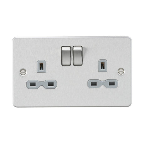 The 13A 2 Gang DP Switched Socket with Twin Earths in brushed chrome features a sleek flat plate design, complete with two plug outlets and vertical switches, making it a stylish choice for modern interiors.