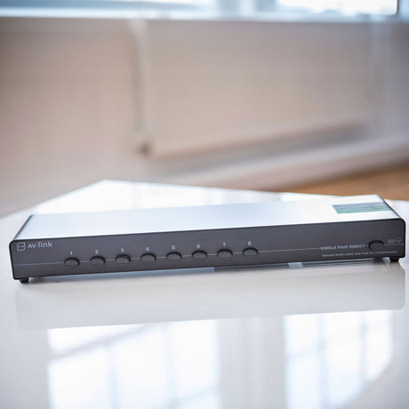 AV:Link AD-SPK18 8-Way Loudspeaker Selector Switch with numbered push-buttons and single pair direct control, shown on a white surface.