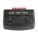 AV:Link AD-SPK21 2-way loudspeaker selector switch in black with two ON/OFF rocker switches and six red spring clip terminals on a white background.
