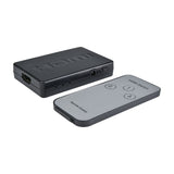 AV:Link 3-port HDMI switch, compact black metal unit with HDMI input port and status LEDs, shown beside grey IR remote with numbered buttons.