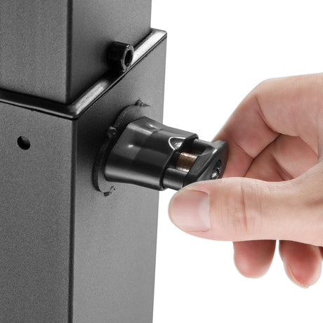 Close-up of a hand adjusting the quick-release height pin on the black metal column of the AV:Link Compact Height Adjustable TV Trolley.