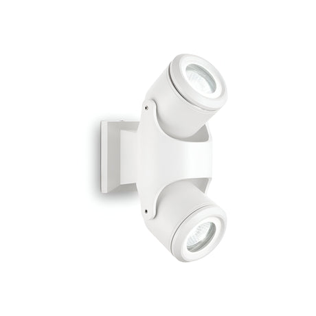 Product Data: The Vista Outdoor Twin Spotlight in white is crafted from powder-coated aluminium, featuring adjustable cylindrical lamps. It is mounted on a sleek, rectangular base, blending seamlessly against a plain white background.