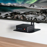 AV:Link ACS300 TV Accessory Shelf by AVSL mounted beneath a wall TV, holding a small black media box with USB ports and red power button.