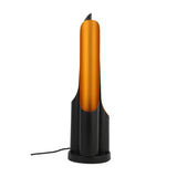 A sleek, modern Stealth Table Lamp in brass and black features a tall, slender design on a matching black base with an attached power cord.