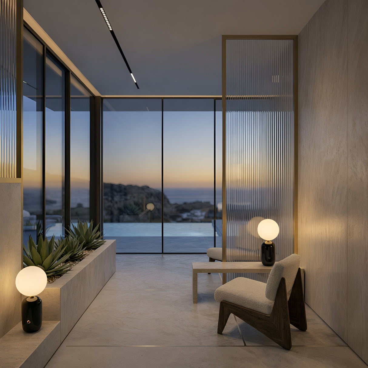 Modern minimalist room with two low chairs, a Pallo Table Lamp - Black, and a planter by floor-to-ceiling windows framing a serene sunset. Neutral tones and sleek design, elevated by minimalist lighting, create a calm, inviting atmosphere.