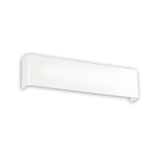 The Canvas LED Wall Light 15.5W 3000K in White, measuring 40cm, is a sleek and modern minimalist rectangular wall sconce featuring energy-efficient LED technology. Its elongated design has a slight curve at one end, adding to its contemporary look when mounted against a plain, light-colored background.