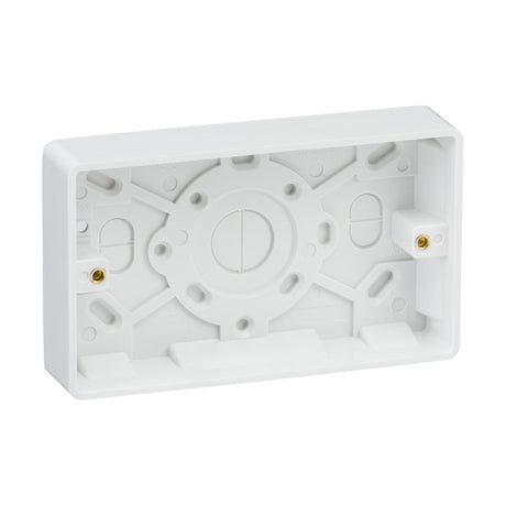 The Double 25mm Pattress Box (Rounded Edge) is a white rectangular mounting back box made of plastic, featuring multiple screw holes and cable entry points. It's perfect for installing electrical devices such as switches or sockets, and its minimalistic design pairs seamlessly with Knightsbridge Curved Edge wiring accessories, providing both functionality and sleek aesthetics.