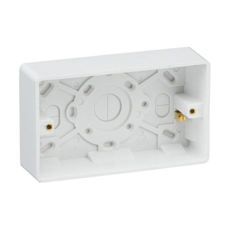 The Double 35mm Pattress Box With Earth Terminal (Rounded Edge) in white plastic features multiple wiring cutouts and two metal screw terminals. This durable rectangular box includes side mounting slots, reflecting the Knightsbridge Curved Edge design.