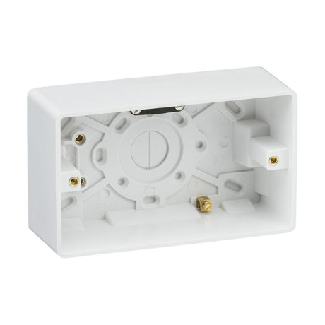 A Double 47mm Pattress Box with Earth Terminal and Cable Strain Relief, made from durable plastic, ensures secure housing for wiring connections. It features multiple entry points and mounting holes, with a rectangular shape, curved edge, and open side for easy installation.