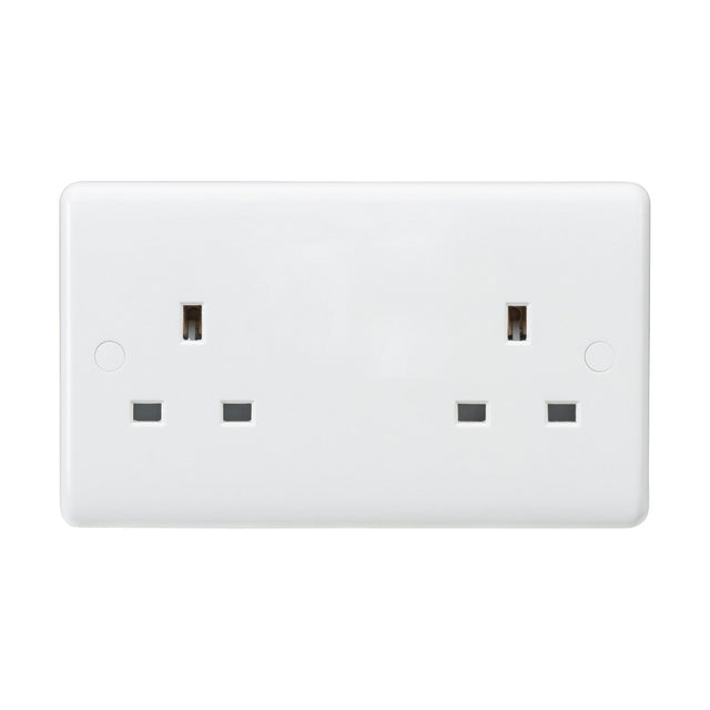 This is an image of the 13A 2 Gang Unswitched Socket (Rounded Edge), a white double electrical wall socket featuring two outlets made from thermoset resin. The socket includes three rectangular pin holes for each outlet, which are typical in the UK, and has an IP20 rating. Its minimalistic design features no visible switches or branding.