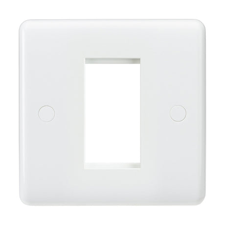 The 1 Gang Modular Faceplate is crafted from durable white thermoset resin and features a central rectangular opening, ideal for accommodating a light switch or outlet. Its smooth surface discreetly conceals two screw covers on either side, providing both functionality and style.