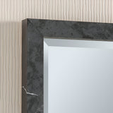 A close-up of the Eden Rectangle Wall Mirror - Dark Marble, showcasing its sophisticated frame with subtle white veining. Positioned against a textured beige wall with vertical lines, this elegant piece enhances any space.