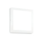 The Zephyrus Square LED Ceiling & Wall Light 3000K - White, 30cm illuminates a rectangular white picture frame on the wall. The cool color temperature of the light subtly highlights the frame's emptiness. When viewed from an angle, a slight shadow is cast, enhancing the depth of this minimalist scene.