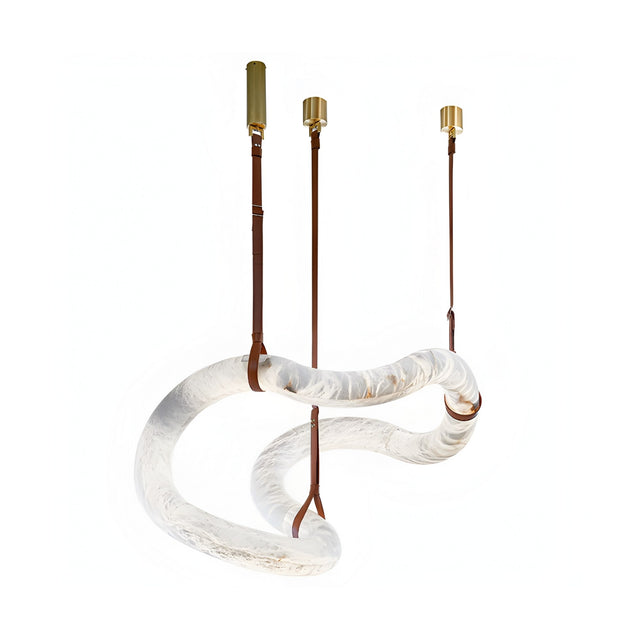 The Serava LED Medium Alabaster Asymmetric Suspension Light in Brown & Soft White showcases a twisted translucent glass tube, suspended by three brass and leather straps, set against a white background.