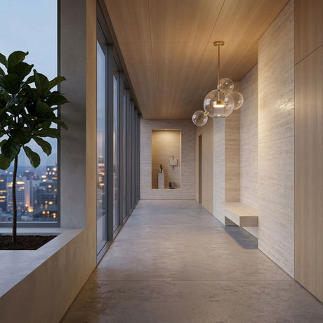 A modern hallway with large city-view windows, a potted plant on the left, a built-in wooden bench on the right, minimalist décor, and a striking Bubble LED Small Glass Pendant Light - Gold overhead.