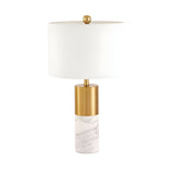 The Valmora 1 Light Monolith Marble Table Lamp features a cylindrical white marble base, brass accents, and a large white drum shade, adding modern elegance to any space.