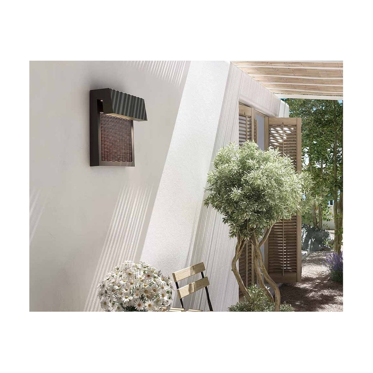 Sisal A/01 LED outdoor wall light in brown, woven fibre panel beneath an angled hood, mounted on an exterior wall near a pergola and plants.