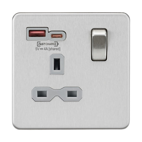 Introducing the 13A 1 Gang SP Switched Socket with Dual USB, featuring a sleek brushed chrome finish and a grey insert. This electrical outlet includes a single switch, one USB-A port, one USB-C port, and a standard three-pin socket. The ports are labeled FASTCHARGE 5V 4A (shared) and support Power Delivery (PD) and Quick Charge (QC) protocols for rapid charging. It also offers essential overload protection to ensure safety.