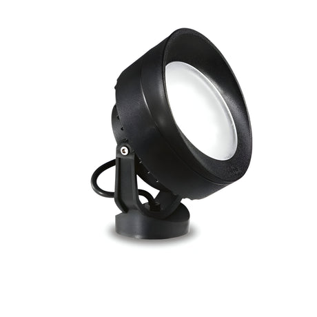 The Point-1 Outdoor Single Spotlight - Black features a round, wide lens and a sturdy mount, displayed against a white background. This spotlight, with an IP66 rating, is angled slightly to the right to showcase its sleek design, corrosion-resistant finish, and the cable extending from its back.