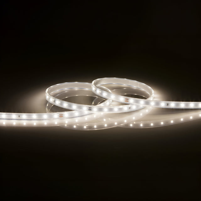 A 24V LED Strip Light IP67 4000K - 5m forms a loose spiral pattern against a dark background. Its dimmable feature emits a soft white light, accentuating the strip's design and providing gentle illumination. The IP67 rating ensures that it remains durable in various environments.