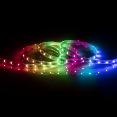 The 24V RGB LED Strip Light IP67 - 30m displays a stunning gradient of vivid colors, including red, pink, green, blue, and yellow, coiling against a dark background. This LED lighting solution offers a bright and visually striking effect.