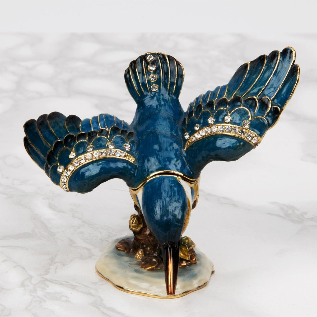 Perched Kingfisher Metal Trinket Box with Hinged Lid in Blue, wings spread with crystal-studded trim and gold detailing, beak pointing down on an enamelled base, shown on a plain white background.