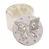 Round silverplated trinket box with crystal-embellished butterfly lid, cream satin-lined interior, shown open on a white background.