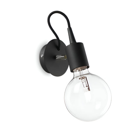 The Ice Wall Light - Black showcases a matte black round base with a stylish curved stem supporting a large clear bulb, all set against a clean white backdrop. Its design is both minimalistic and contemporary, making it an ideal addition to any modern space.