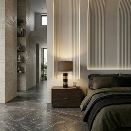 Modern bedroom with a dark wooden nightstand, the Arvella 1 Light Striped Marble Table Lamp in black & gold, green bedding, textured wall panels with soft lighting, marble floor, and an open hallway with built-in shelves and large windows.