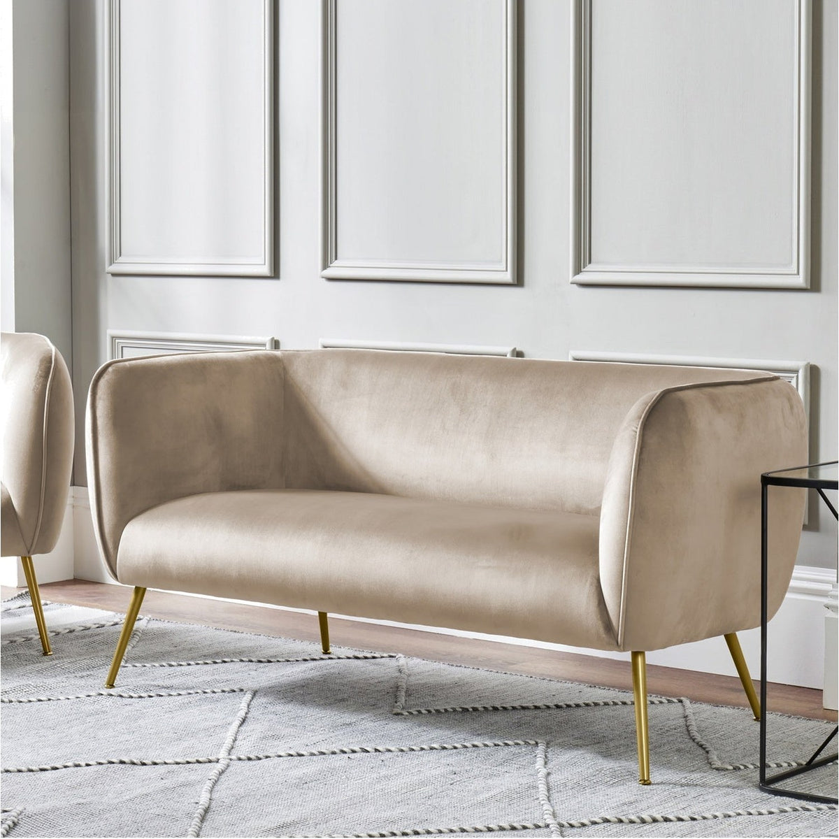 Lucca Biscuit Velvet & Iron Sofa, 142cm, with curved biscuit velvet upholstery and slim gold-tone metal legs, shown in a living room against panelled walls.