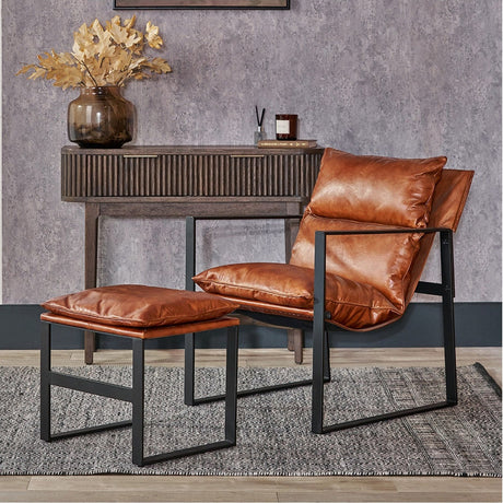 Nico Vintage Brown Leather Chair & Footstool with cushioned seat, back and matching stool, both on angular black metal frames, shown in a living room beside a wooden console table.