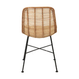 Rear view of a Rattan Core & Black Iron Dining Chair with a natural woven rattan back and seat on black metal legs with an X-brace, shown against a white background.