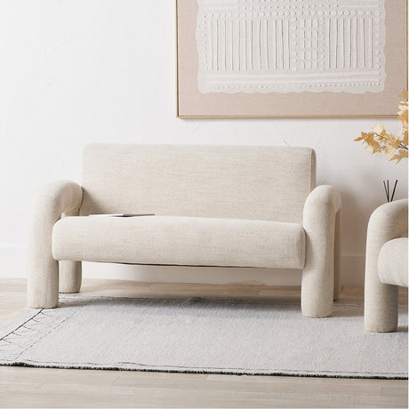 Ravello White Textured Fabric Armed Sofa, 145cm, with rounded bolster arms and legs, shown in a living room beneath a framed textured artwork.