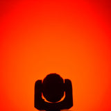 QTX 80W RGBWA COB LED moving head light by AVSL, silhouetted head and yoke against a saturated red-orange background.