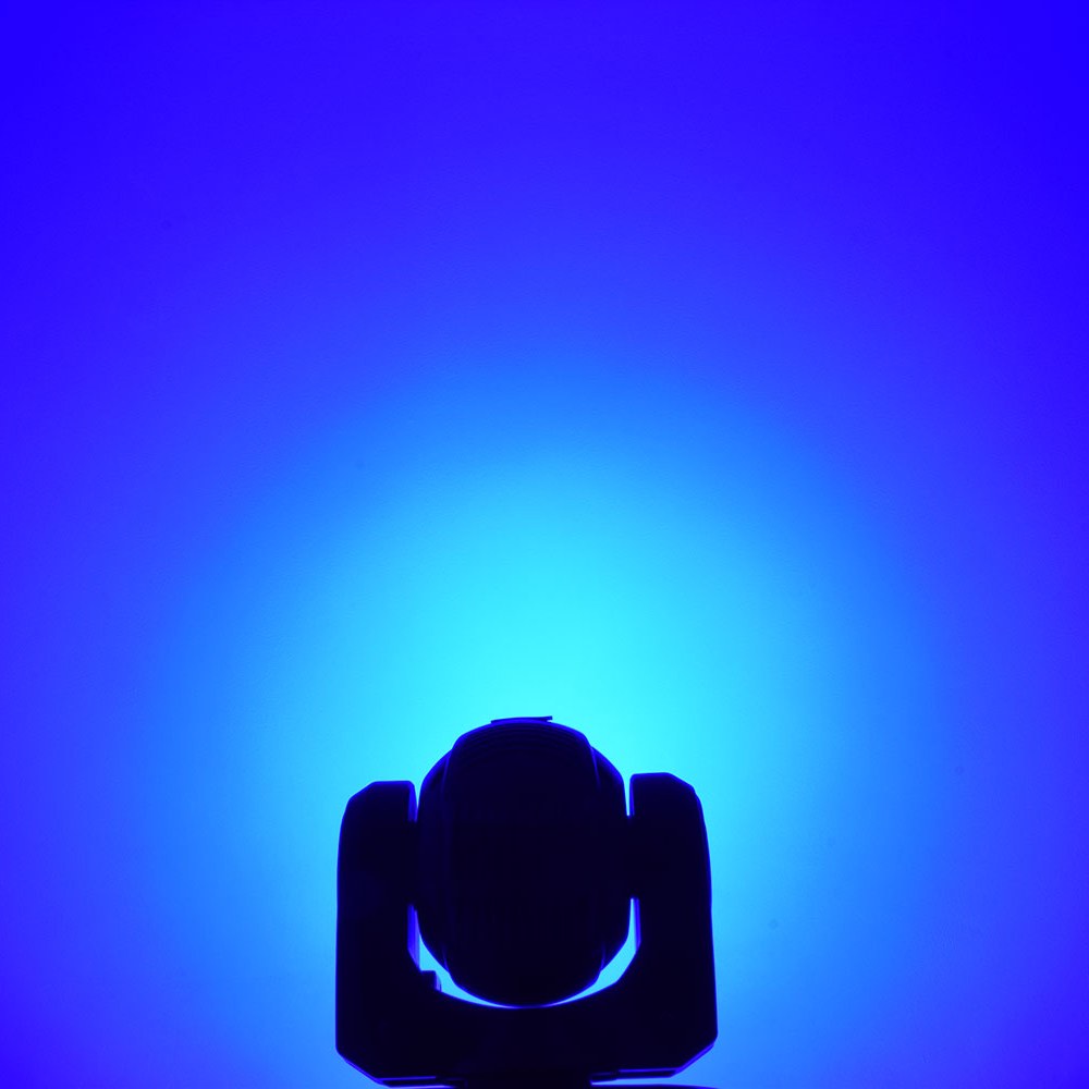 QTX 80W RGBWA COB LED moving head light by AVSL shown in silhouette against a blue wash beam projected onto the backdrop.