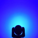 QTX 80W RGBWA COB LED moving head light by AVSL shown in silhouette against a blue wash beam projected onto the backdrop.