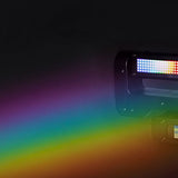 Citronic Infinity RGB Flying Strobe Moving Head by AVSL projecting a rainbow beam from its lit LED panel against a dark background.