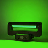 Citronic Infinity RGB Flying Strobe Moving Head by AVSL, shown front-on with its LED panel lit green against a green-washed background.