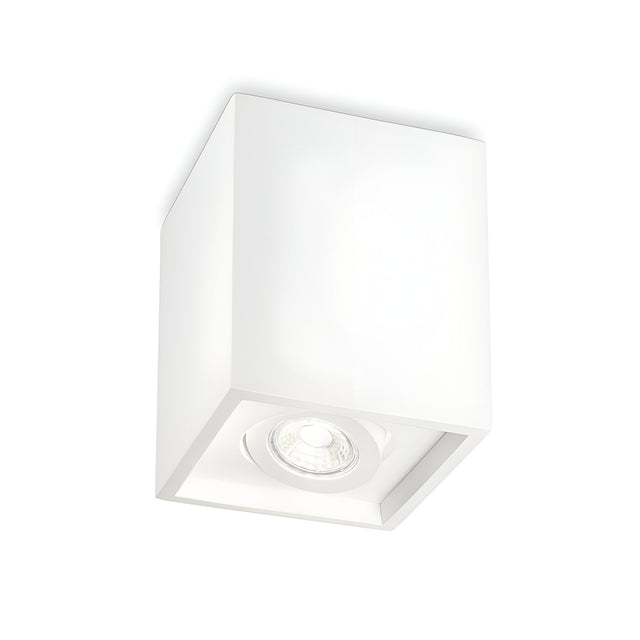 The Muse Square Downlight - White is a cube-shaped ceiling light fixture with a minimalist design and plaster finish. It features a single bulb socket on the underside, offering a modern look with clean lines and a smooth surface.