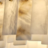 Close-up of softly veined, translucent panels on the Valeris 14 Light Layard Panel Alabaster Linear Chandelier in Soft White & Brass, arranged vertically and backlit for a warm glow—ideal as layered stone lighting or a statement chandelier.