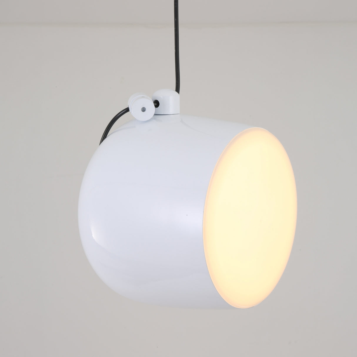 The Mono LED Pendant Light - White features a sleek, rounded design and flat circular front, hanging elegantly from the ceiling to emit a warm glow—perfect for adding modern style to any kitchen.