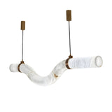 Niori Zareon LED curved alabaster chandelier in soft white with brushed brass straps and twin cylindrical canopies on black cables, white background.