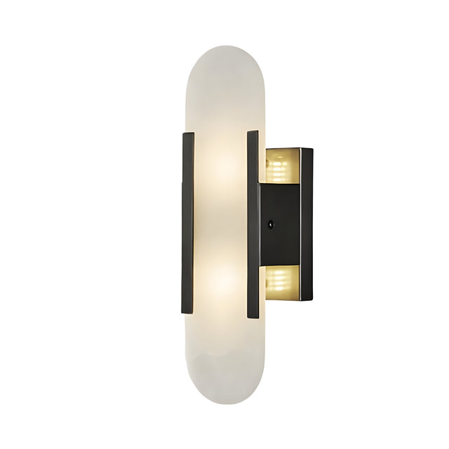 The Lirone 1 Light Small Vertical Capsule Alabaster Wall Light in soft white and black features an oval alabaster shade with two vertical black accents on a rectangular base, providing gentle, diffused lighting for modern interiors.