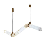 Niori Zareon LED chandelier with three alabaster tubes in a stepped zig-zag, brushed brass cuffs and twin canopies, on a white background.