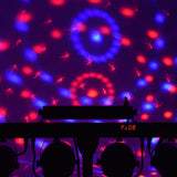QTX Multi-Bar 5-in-1 RGBW Effects Lighting Bar by AVSL projecting red and blue rotating patterns with LED display reading Pc08 on the rear control panel.