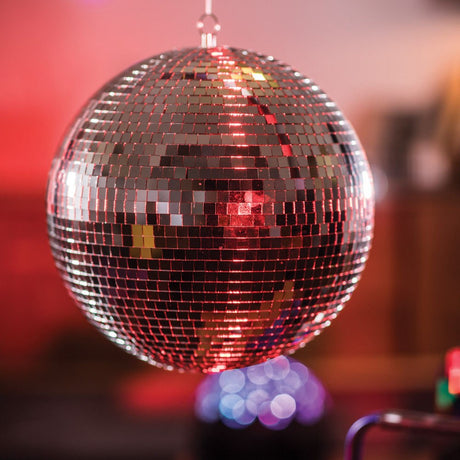 QTX 30cm glass disco ball by AVSL, a mirror-faceted sphere hanging from a metal ring, catching red pin spot light against a blurred party backdrop.