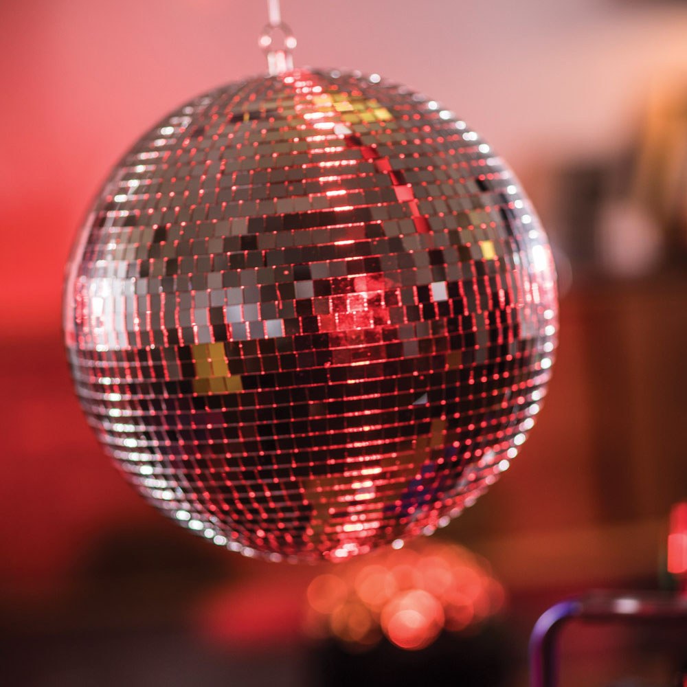 QTX 30cm glass disco ball by AVSL, a mirror-faceted sphere suspended from a metal ring, reflecting red light across a blurred venue background.