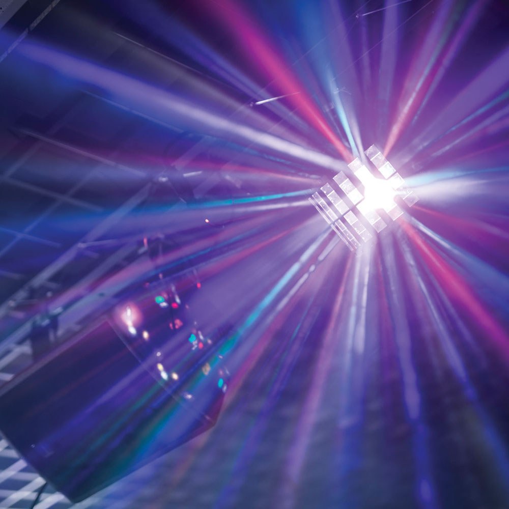 QTX Derby9 LED derby effect light by AVSL projecting multi-colour rotating beams in purple, blue, red and white across a darkened venue ceiling.