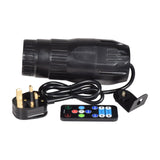 QTX 10W RGBW LED spotlight by AVSL in black with UK plug lead, mounting bracket and wireless remote control, shown on a white background.
