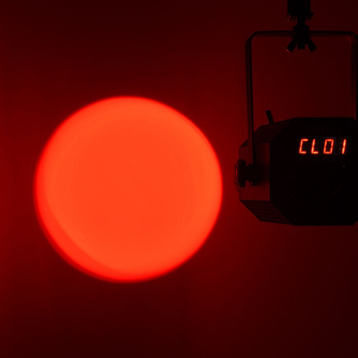 Citronic PAR60-RGB LED profile spotlight by AVSL projecting a red circular beam with CL01 shown on its rear digital display.